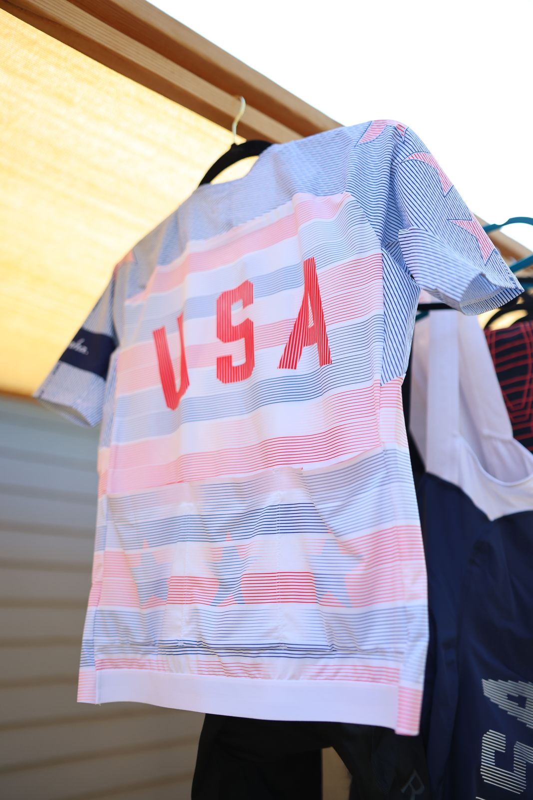 USA Rapha jersey drying on the line under the shade sail, USA lettering on the back